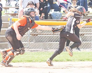 SOFTBALL - (1) Ali Prologo of Canfield tries to get away from catcher Emily Price during thier game Thursday afternoon in Boardman.