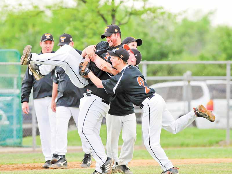 Springfield head baseball coach Matt Weymer is picked up during the celbratin by his players Aaron Yoder and Mike Semach.