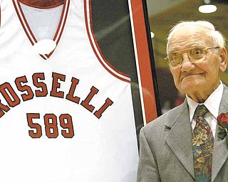 Don Rosselli is honored with a jersey in his name during a ceremony at halftime at Beeghly Stadium marking his years as a YSU basketball coach. The number589 on the jersey denotes the number of wins YSU had under the instruction of Rosselli (Vindicator/Mark W. Lipczynski).