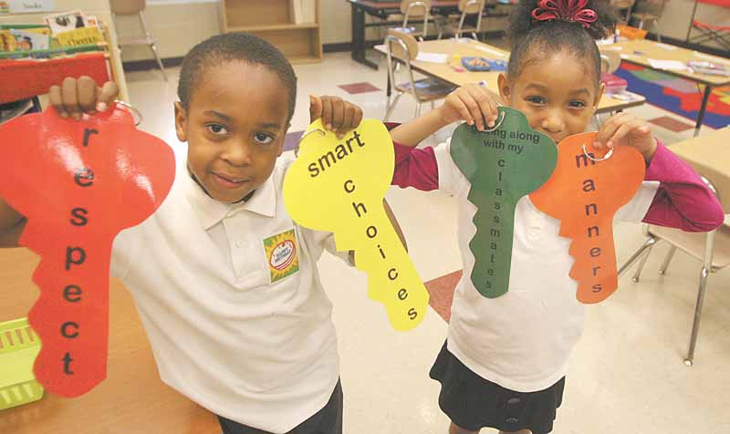 Taft Elementary School kindergartners, from left, Brea’on Slocum and Reagan Nevels hold keys designating characteristics they’ve learned about in Project KIND. The program by Community Solutions Association on Thursday presented the last of 12 weekly sessions.