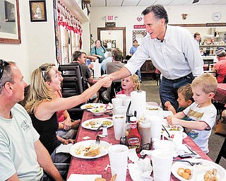 Possible 2012 presidential hopeful, former Massachusetts Gov. Mitt Romney shakes hands with people at Farm Boys restaurant during a visit, Saturday May, 21, 2011 in Chapin, S.C. The former Massachusetts governor was making his first visit Saturday to South Carolina since taking the first steps toward a 2012 White House run.