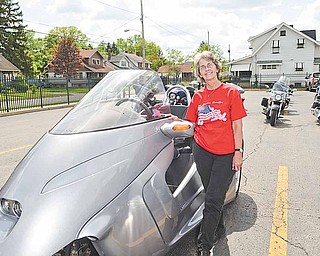 Gail Taylor of New Springfield stands with with her bike “Silver Lady,” a three-wheeled Thoroughbred Motorsports Stallion, which was blessed Saturday afternoon. 
