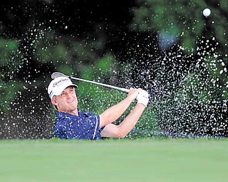 David Toms hits out of a bunker on the 17th hole during the third round of play at the Colonial golf tournament in Fort Worth, Texas, Saturday, May 21, 2011. 