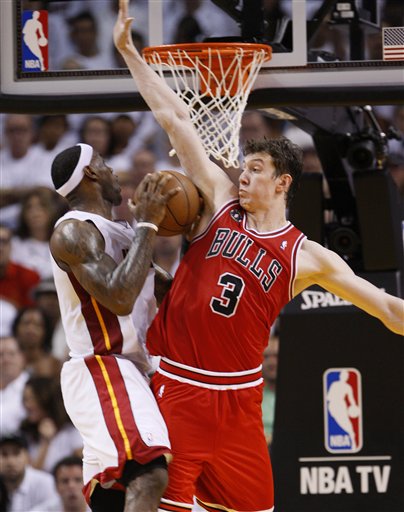 Miami Heat's LeBron James, left, goes up for a shot against Chicago Bulls' Omer Asik (3) during the second half of Game 3 of the NBA Eastern Conference finals basketball series in Miami, Sunday, May 22, 2011.