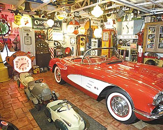 Inside the station is a 1959 Chevrolet Corvette, which is surrounded by historic gas pumps and other car-related memorabilia, including traffic lights and a motor-ignition tester.