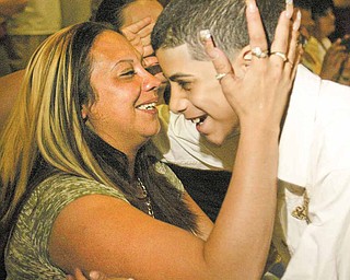 Williamson Elementary School fifth grader Angelo Rosado hugs his mom, Keyshla Rivera, Monday morning during a tribute to mothers at the school.