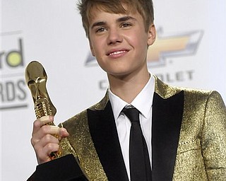 Singer Justin Bieber poses in the press room at the 2011 Billboard Music Awards in Las Vegas on Sunday, May 22, 2011.