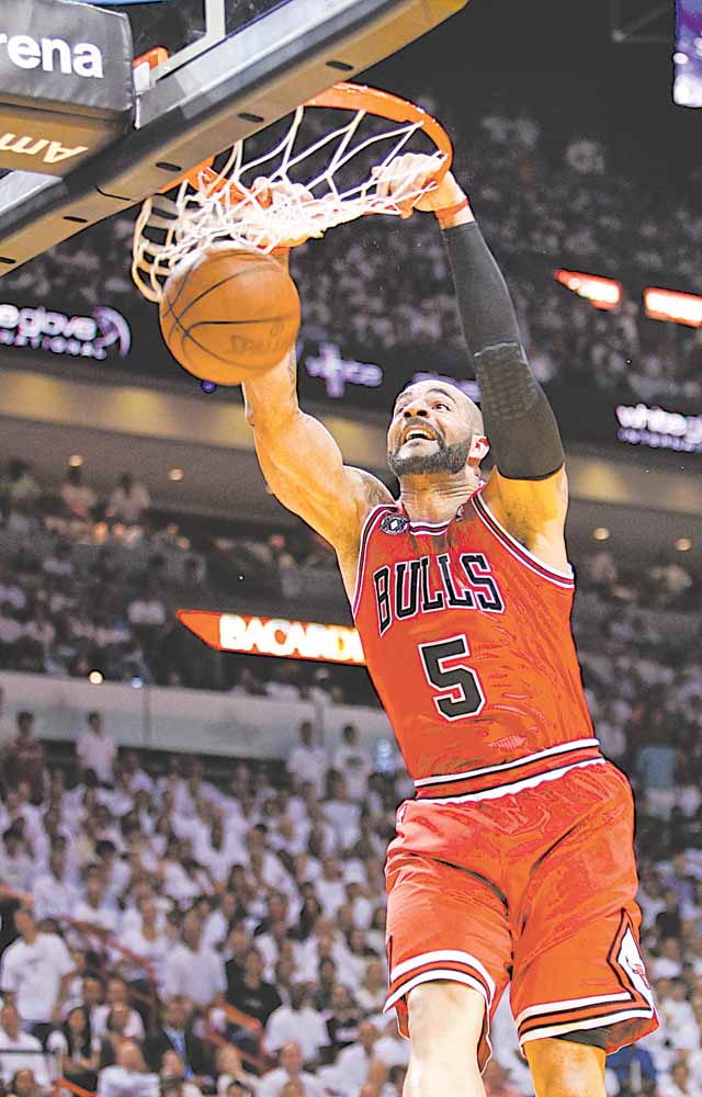 Chicago Bulls' Carlos Boozer dunks the ball during the first half of Game 4 of the NBA Eastern Conference finals basketball series against the Miami Heat in Miami, Tuesday, May 24, 2011.