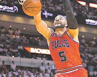 Chicago Bulls' Carlos Boozer dunks the ball during the first half of Game 4 of the NBA Eastern Conference finals basketball series against the Miami Heat in Miami, Tuesday, May 24, 2011.