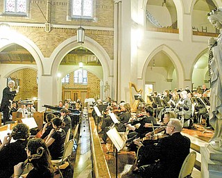 Conductor Michael David Gelfand, a music professor at YSU, leads the Youngstown Symphony Orchestra on Tuesday during a concert marking the 100th anniversary of St. Patrick Church in Youngstown.