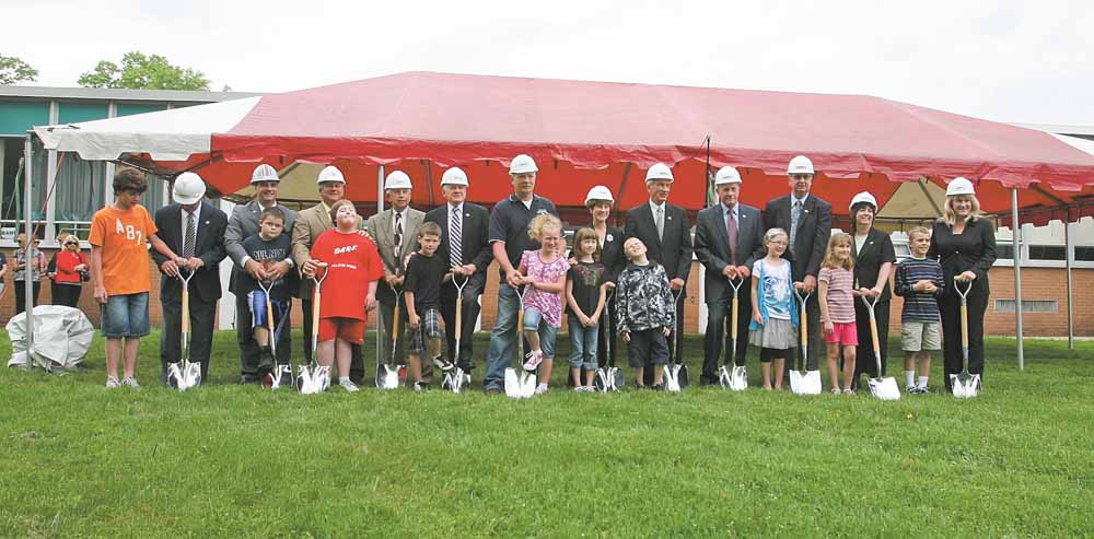 Board members, school officials,  students and others working on the  $50 million Austintown schools construction project gathered Tuesday, top, to break ground outside Frank Ohl Intermediate School.