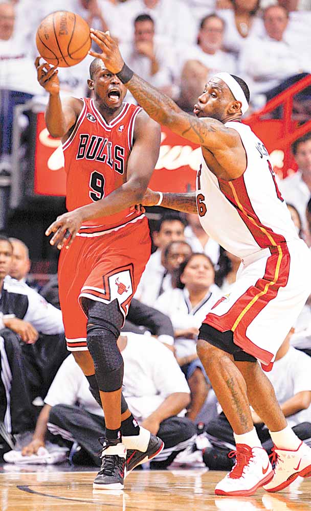 Miami Heat's LeBron James (6) blocks a pass by Chicago Bulls Luol Deng (9) during  the second half of Game 4 of the NBA Eastern Conference finals basketball series in Miami, Tuesday, May 24, 2011.