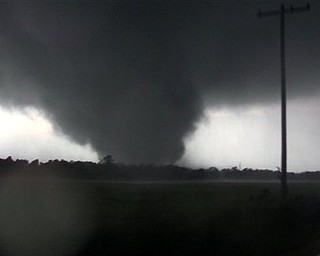 This frame grab from video shows a massive tornado on Sunday, May 22, 2011, outside Joplin, Mo.  The tornado tore a 6-mile path across southwestern Missouri killing at least 89 people as it slammed into the city of Joplin, ripping into a hospital, crushing cars like soda cans and leaving a forest of splintered tree trunks behind where entire neighborhoods once stood.