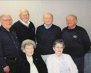 Making plans for the South High School Alumni Reunion on June 17 are, seated from left to right, Elberta Bullman Scott (Class of 1939), and Delores Rauschenberg Brindle (Class of 1946); and, standing, Chuck Whitman (Class of 1946), Dick Bennett (Class of 1951), Sonny Friend (Class of 1949), and John Athanasen (Class of 1959).
