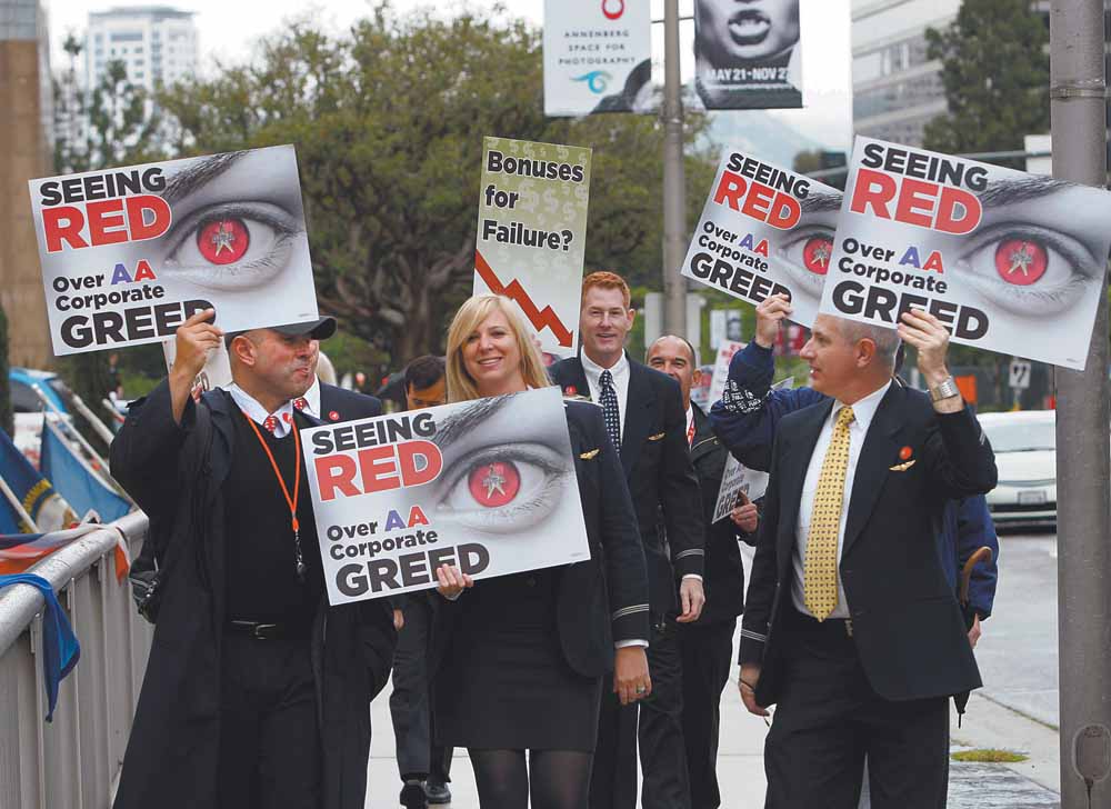In this May 18, 2011 file photo, American Americans pilots, flight attendants and others picket outside the annual shareholders meeting of AMR Corp., parent company of the airline, outside the Hyatt Regency Century Plaza Hotel in Los Angeles. When it's time for the annual meeting and things might get ugly, there's no place like the road. 