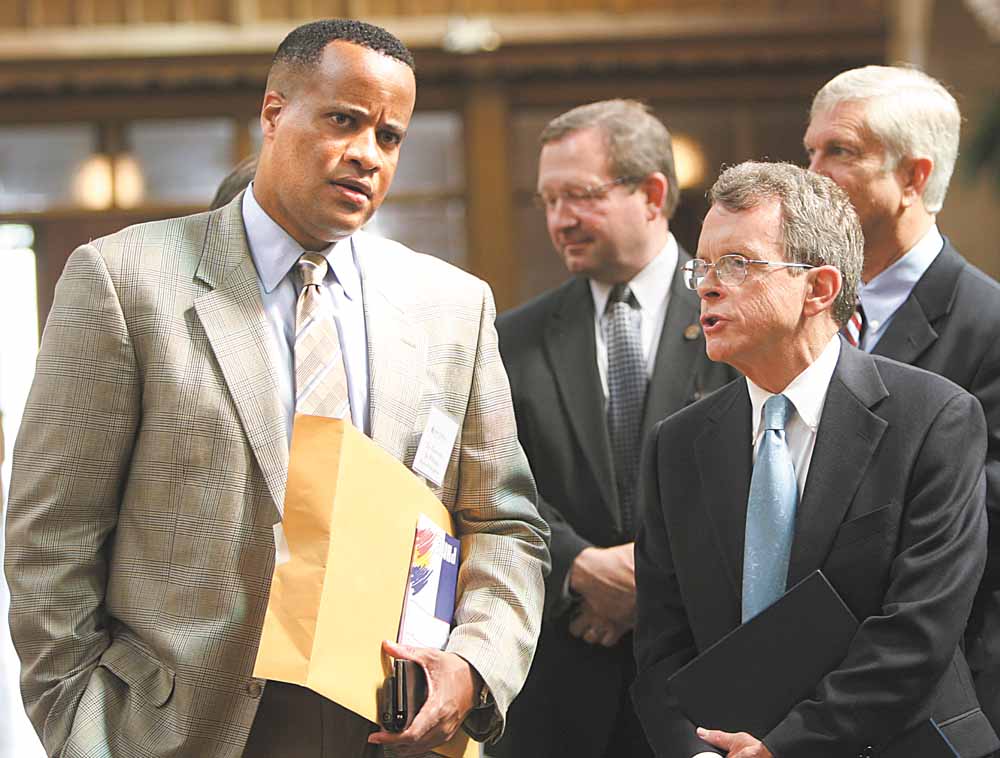 Attorney General Mike DeWine, right, talks with Mayor Jay Williams after announcing the Fugitive Safe Surrender program would come to Youngstown next year. The two were part of a safety summit Wednesday at St. Dominic Church on the city’s South Side.