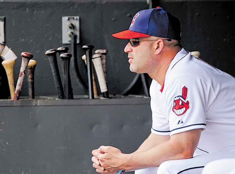 In this photo taken May 25, 2011, Cleveland Indians manager Manny Acta watches from the dugout during a baseball game against the Boston Red Sox in Cleveland. The club's second-year manager spent all spring telling anyone who would listen that he expected the Indians, who lost 93 games last season, to contend in 2011. With Acta making smart, timely moves _ and a little luck _ they have baseball's best record.(AP Photo/Mark Duncan)