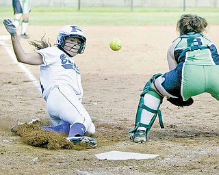 Poland's Kalie Benson slides into home to score as West Branch catcher Cheyenne Miller waits for the throw.
