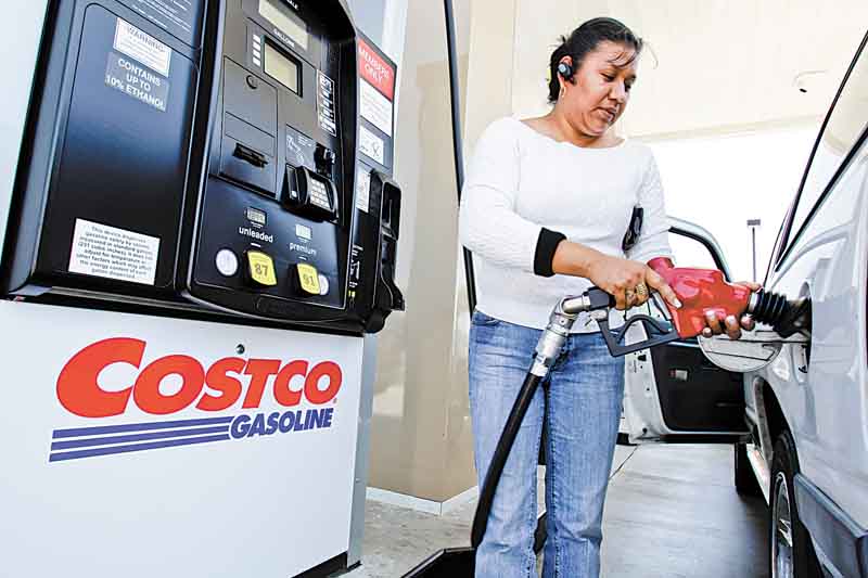A customer pumps gas at a Costco station in Redwood City, Calif., Tuesday, May 24, 2011. Costco's net income rose 6 percent in its fiscal third quarter, with growing membership numbers pushing sales both at home and abroad. (AP Photo/Paul Sakuma)