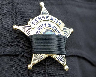 All officers who attended Friday’s ceremony wore black bands over their badges.