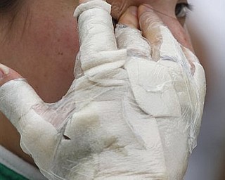 FILE - In this May 21, 2011, file photo, Simona De Silvestro, of Switzerland, wipes her eyes after she qualified on her final attempt on the opening day of qualifications for the Indianapolis 500 auto race at Indianapolis Motor Speedway in Indianapolis. De Silvestro burned her hands in a crash two days earlier. (AP Photo/Darron Cummings, file)
