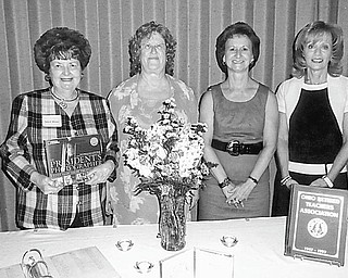 Remembering teachers: At its annual In-Memoriam and Remembrance Service, the Mahoning Retired Teachers Association eulogized deceased teachers from Mahoning County. During the service, Sally Winsen, at left, presented to Linda Vuletich, MRTA president, standing next to her, this year’s memorial book by John Bredar, titled “The President’s Photographer.” The book will become part of the permanent collection of the Youngstown Public Library on behalf of the John M. Knapick Memorial for deceased MRTA members. Continuing from left to right are Martha Lopez, Remembrance chairwoman, and Joan Sonnett, Remembrance committee member.