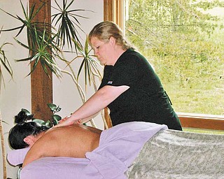 Holli Aneshansley, owner of The Natural Remedies Spa, gives Stacey Willis an aromatherapy massage.