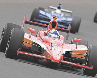 IndyCar driver Dario Franchitti, of Scotland, heads into a turn on the final day of practice for the Indianapolis 500 auto race at the Indianapolis Motor Speedway in Indianapolis, Friday, May 27, 2011. The 100th anniversary running of the Indianapolis 500 is scheduled for Sunday. (AP Photo/Tom Strattman)