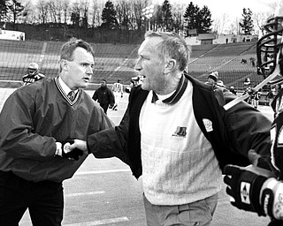 Jim Tressel shakes hands with Akron head coach Gerry Faust after Youngstown State defeated the Zips at the Rubber Bowl in 1993.