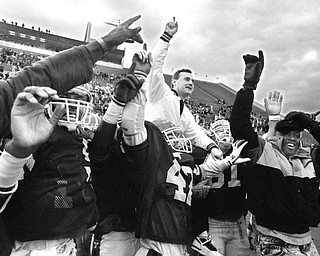 Youngstown State University coach Jim Tressel celebrates an undefeated season in 1990 after defeating the University of Maine.