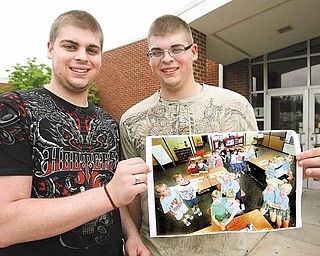Alex and Christian Syrianoudis, 18, are one of 10 sets of twins and a set of triplets graduating from Canfield High School on June 12. The brothers are holding a picture taken when they were in kindergarten that shows several of the sets during a class.