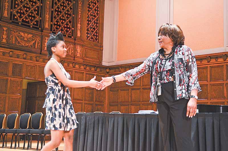 Chaney High School senior Dasia Square practices walking across the stage at Stambaugh Auditorium in Youngstown. Commencement practice was Wednesday afternoon; today is the real thing for Square and her classmates.