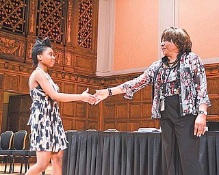 Chaney High School senior Dasia Square practices walking across the stage at Stambaugh Auditorium in Youngstown. Commencement practice was Wednesday afternoon; today is the real thing for Square and her classmates.