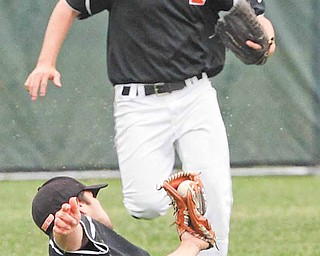 Springfield’s Josh Horn watches as shortstop Cody Pitzo comes up with a diving catch during the Division IV baseball final against Columbiana. The Tigers are a game away from from a state fi nal berth.