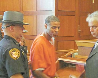 Frederick D. Johnson is led from the courtroom after Judge Peter Kontos of Trumbull County Common Pleas Court sentenced Johnson to 32 years in prison for being a “major drug offender.”