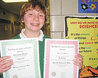 Science comes naturally to him: Brennan Bizon holds two certificates he received from The Ohio Academy of Science for Superior ratings he earned for his science project, “Which Ball Bounces Higher?” Brennan, a seventh-grader at Holy Family School in Poland, earned a Superior rating at the school’s science fair before going on to win the academy awards at the Lake-to-River District Science Day at Youngstown State University and the State Science Day at Ohio State University in Columbus. He said he was inspired by basketball to find out whether a larger or a smaller ball bounces higher.