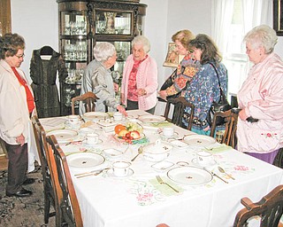 Pattern with a purpose: Cecilia Cooper, center, explains the history of the British Ironstone tea-leaf pattern dinnerware on display at the Hubbard Historical Society’s McBride House, at 27 Hager St., to members of the Coitsville-Campbell Homemakers. The group toured the house recently. There is no open house scheduled at McBride for the month of June. Arrangements to tour the house can be made by phoning Cooper at 330-534-4247.