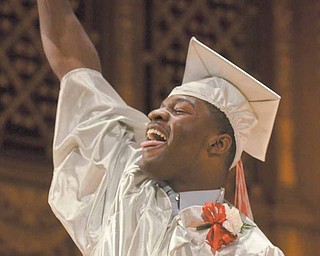 Chaney High School graduate Brandon Davis celebrates after receiving his diploma Thursday afternoon in Stambaugh Auditorium. He’s just one of about 200 members of Chaney’s 2011 class.