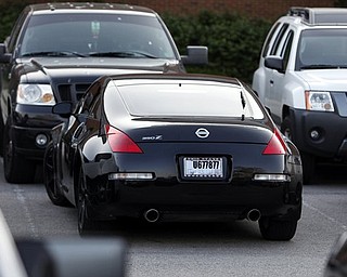 Ohio State quarterback Terrelle Pryor arrives in this Nissan 350Z, center, to a players only meeting Monday, May 30, 2011, at the Woody Hayes Complex, in Columbus, Ohio. (AP Photo/Terry Gilliam)