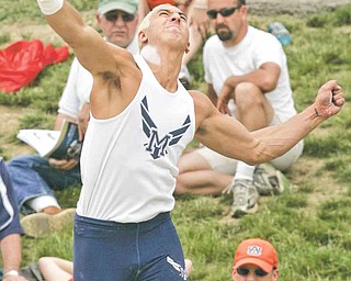 McDonald's Matthias Tayala releases his second throw in the shot put finals during the boys Division III State High School Track Meet at Ohio State University Friday, June 3, 2011. Tayala's throw went 64' 8" to give him the title.