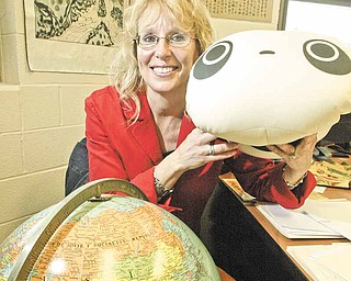 William d LEwis the vindicator Girard Jr HS Principal Louise Mason shows a stuffed panda toy presented to her while see was in China recently. She visited schools in China.