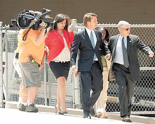 John Edwards, center, enters the Federal Building in downtown Winston-Salem, N.C. on Friday, June 3, 2011. A grand jury indicted the two-time presidential candidate on Friday, accusing him of trying to protect his political ambitions by soliciting and secretly spending more than $925,000 to hide his mistress and their baby from the public. (AP Photo/Winston-Salem Journal, Jennifer Rotenizer)