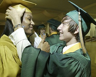 William Lewis the vindicator Ursuline grad Amani Noble gives the thumbs up sign as fellow grad Taylor Hartman adjusts her cap before Saturday ceremony at Stambaugh Auditorium.