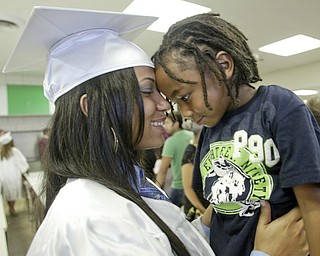 William D Lewis The Vindicator Boardman HS grad Shavai Owens, one of 6 wounded in Febuary shooting near YSU, hugs her brother Dinari Ferguson, 4, after commencement which was held Sunday at the HS.