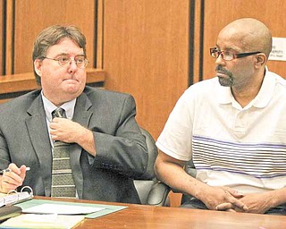 Anthony Sowell, left, the man charged with killing 11 women and dumping their remains around his property and home, appears in Common Pleas Court with his attorney John Parker as jury selection proceeds in his trial in Cleveland on Monday, June 6, 2011. (AP Photo/Marvin Fong, Pool)