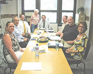 Educational interlude: Cecilia Cooper of the Hubbard Historical Society recently presented a commemorative postcard to Hubbard School Board members. The postcard shows the four school buildings that are being replaced by the new educational campus (K-12) on Hall Avenue. From left to right are Rhonda Baldwin; Dr. Benjamin Hayek; Raymond DeLuco; Cooper; Richard Buchenic, superintendant; Martin Franko; Frank Maietta and Linda Silvidi.