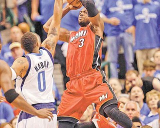 Miami Heat's Dwyane Wade (3) shoots over Dallas Mavericks' Shawn Marion (0) during the first half of Game 4 of the NBA Finals basketball game Tuesday, June 7, 2011, in Dallas. (AP Photo/David J. Phillip)