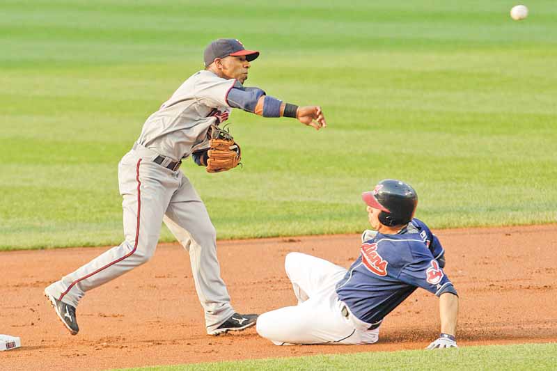 Minnesota Twins shortstop Alexi Casilla throws to first base after getting Cleveland Indians' Asdrubal Cabrera out at second base in the first inning in a baseball game, Tuesday, June 7, 2011, in Cleveland. Carlos Santana was out at first base for the double play. The Indians won 1-0. (AP Photo/Tony Dejak)