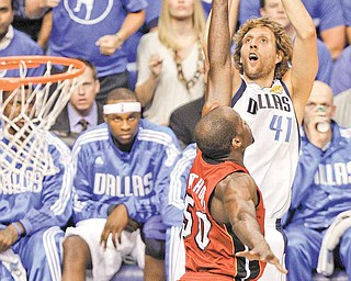 Dallas Mavericks' Dirk Nowitzk shoots over Miami Heat's Joel Anthony (50) during the first half of Game 4 of the NBA Finals basketball game Tuesday, June 7, 2011, in Dallas. (AP Photo/LM Otero)