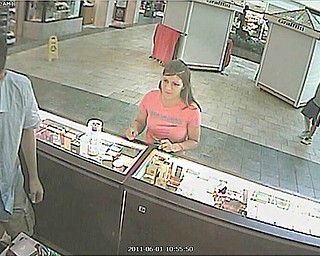 Poland Village police need help identifying this woman who they suspect stole another woman’s debit card and used it to purchase more than $250 worth of merchandise at local stores. The woman, pictured here at the Perfume Collection kiosk at Southern Park Mall, was seen driving away in a silver, four-door Chevrolet Impala.